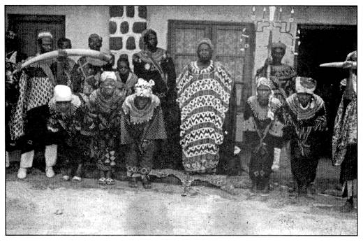 Fon John Yai Kwanga in his palace with some of his wives